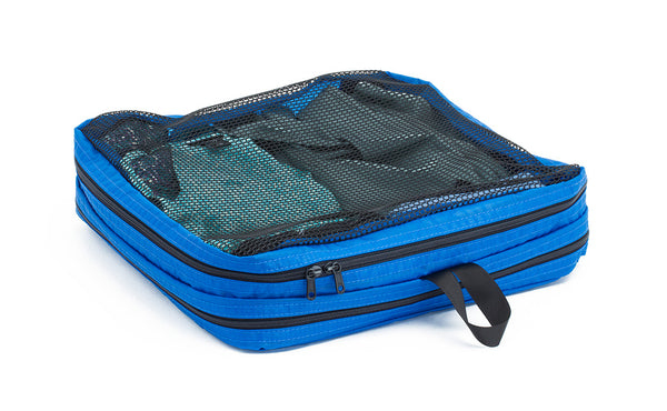 A filled and zipped closed Island (blue) Aether Large Laundry Aeronaut 30 Packing Cube showing the mesh side.